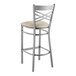 A Lancaster Table & Seating metal bar stool with a light gray cushion.