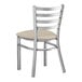A Lancaster Table & Seating clear coat finish metal ladder back chair with a light gray vinyl padded seat.