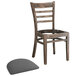 A Lancaster Table & Seating wood ladder back chair with a detached dark gray vinyl seat