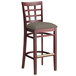 A Lancaster Table & Seating mahogany wood bar stool with a taupe cushion seat.