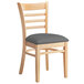 A Lancaster Table & Seating wooden ladder back chair with a dark gray vinyl seat.