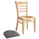 A Lancaster Table & Seating wooden restaurant chair with a detached dark gray vinyl seat