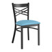 A Lancaster Table & Seating black metal chair with a blue vinyl cushion.