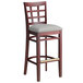 A Lancaster Table & Seating mahogany wood bar stool with a light gray cushion seat.