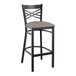 A Lancaster Table & Seating black cross back bar stool with a dark gray cushion.