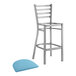 A Lancaster Table & Seating ladder back bar stool with blue vinyl padded seat.