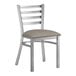 A Lancaster Table & Seating silver metal ladder back chair with a dark gray vinyl padded seat.