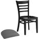 A Lancaster Table & Seating black wood ladder back chair with a detached dark gray vinyl seat