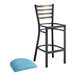 A Lancaster Table & Seating distressed copper ladder back bar stool with a blue cushion.