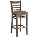 A Lancaster Table & Seating wood ladder back bar stool with a taupe cushion seat.