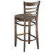 A Lancaster Table & Seating wood ladder back bar stool with a taupe vinyl seat.