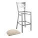 A Lancaster Table & Seating metal bar stool with a light gray cushion on the seat
