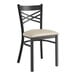 A black Lancaster Table & Seating metal chair with a light gray cushion.