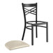 A black Lancaster Table & Seating metal chair with a light gray cushion on the seat.