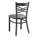 A black metal Lancaster Table & Seating chair with a dark gray cushion.