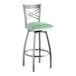 A Lancaster Table & Seating clear coat finish cross back swivel bar stool with a seafoam vinyl padded seat.