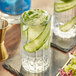 A close-up of a glass of Lyre's non-alcoholic gin with cucumber slices.