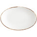A Fortessa white china coupe platter with brown rim.