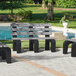 A group of gray MasonWays Dura-Benches with black legs next to a pool.