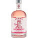 A Lyre's Pink London Spirit gin bottle filled with pink liquid on a bar.