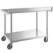 A Regency stainless steel work table with undershelf and casters.