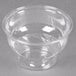 A clear plastic Fabri-Kal sundae cup on a gray surface.