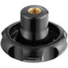 A black plastic knob with a gold nut.