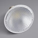 An Eiko 10 watt dimmable LED flood light bulb with a white metal mesh over the light.