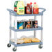 A Vollrath gray plastic utility cart with three shelves holding food and beverages.