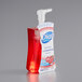A bottle of Dial Power Berries Antibacterial Foaming Hand Wash with red liquid inside.