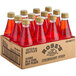 A case of 12 Rose's Strawberry Syrup glass bottles.