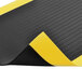 A black and yellow Notrax Airug anti-fatigue mat with a black stripe.