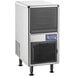 An Avantco undercounter ice machine with a stainless steel and black cover with a vent.