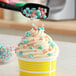 A frosted cupcake with Fizzy Pink and Blue Cotton Candy Cluster sprinkles.