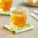 A glass of Old Orchard apple juice with ice on a table