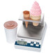 An Edlund digital portion scale with an ice cream cone platform weighing two ice cream cones and a cup.