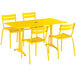 A yellow Lancaster Table & Seating outdoor table and chairs set.