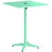 A seafoam green Lancaster Table & Seating bar height table with a black metal top.