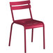 A red metal Lancaster Table & Seating chair with a seat and back.
