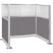 A Versare Hush Panel U-shaped cubicle with gray panels and a silver frame.