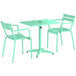 A Lancaster Table & Seating seafoam green table with umbrella hole and two arm chairs.