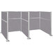 A Versare Hush Panel double cubicle with cloud gray panels and metal legs.