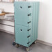 A blue Cambro double compartment tray and sheet pan carrier on wheels.