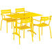 A yellow Lancaster Table & Seating table with chairs and an umbrella hole.
