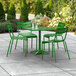 A Lancaster Table & Seating green table and chairs on a patio.