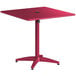 A red Lancaster Table & Seating outdoor table with a black square top.