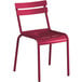 A red metal Lancaster Table & Seating side chair with a seat and back.