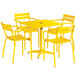 A yellow table and chairs set up on an outdoor patio.