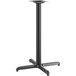 A Lancaster Table & Seating black metal bar height table base with a square base and pole.