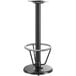 A Lancaster Table & Seating black metal bar height table base with a foot ring.
